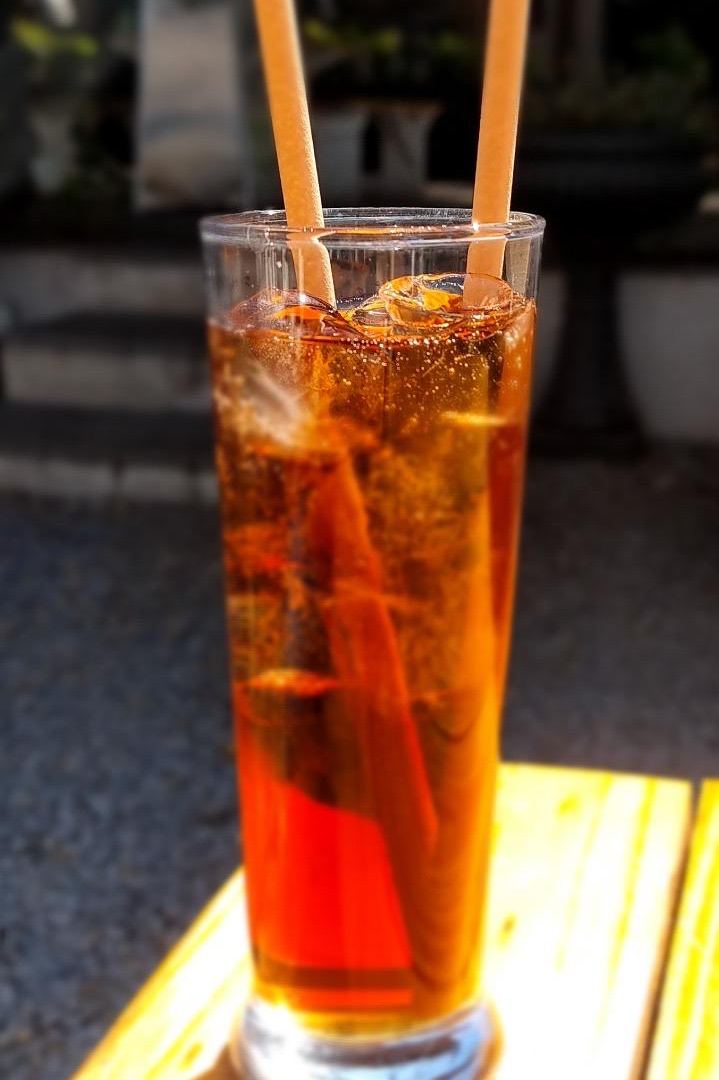 Natural compostable Euro Straws in a tall glass of iced tea